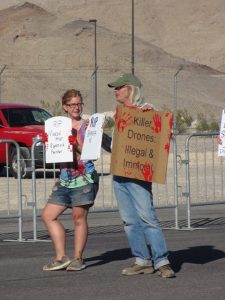 Kelsey Chalmars and John Heid blockading Creech drone base, photo by Felice Cohen-Joppa