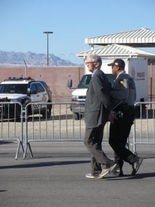Catholic Worker archivist Phil Runkel being taken into custody at Creech drone base, photo by Felice Cohen-Joppa