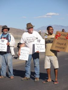 Brian Terrell, Steve Jacobs and Austin Cook blockade Creech drone base, photo by Felice Cohen-Joppa
