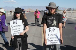 Alexandria Addesso and Sam Yergler block road into Creech drone base, photo by Mike Wisniewski